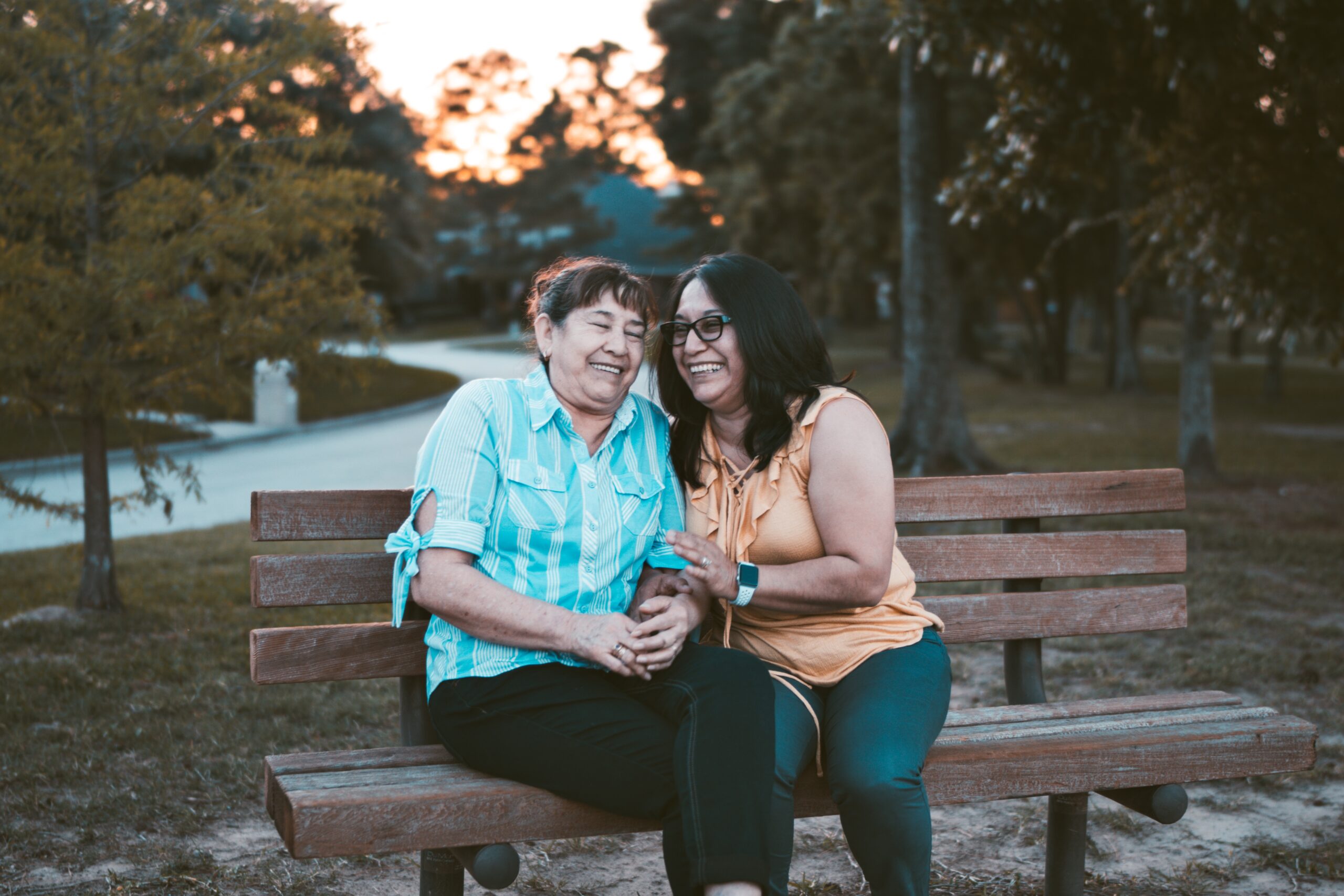 Older mother and daughter on park bench